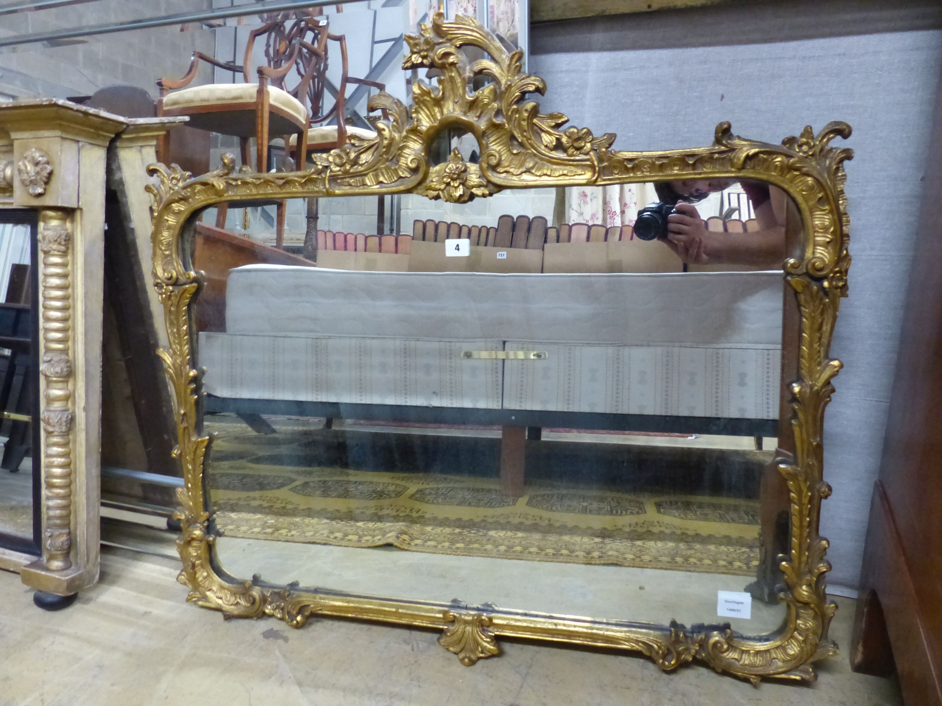 A Victorian style gilt framed wall mirror with pierced surmount and scrolling foliate border, W.94cm H.89cm